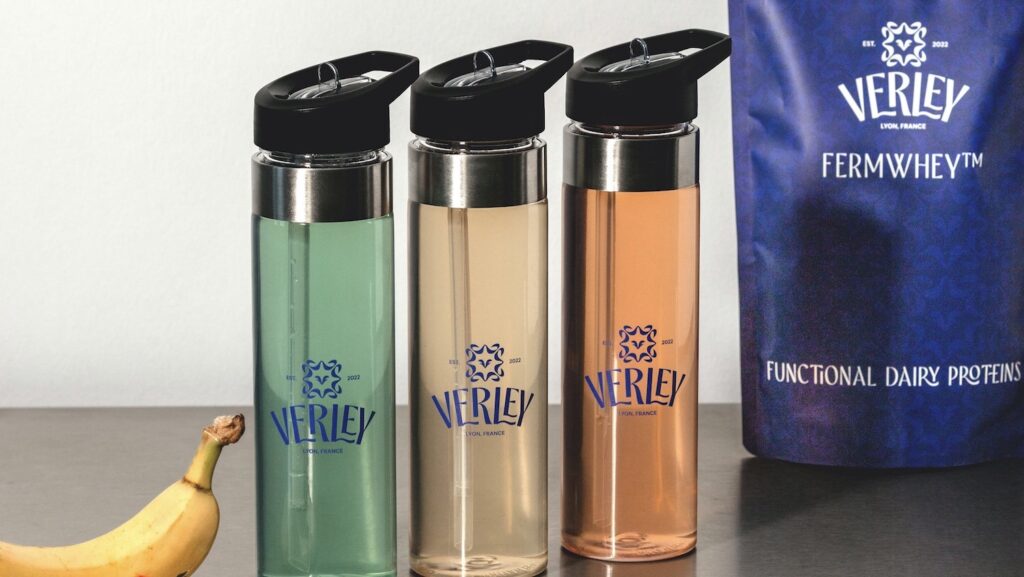 Three water bottles and bag of Verley functional dairy protein in background