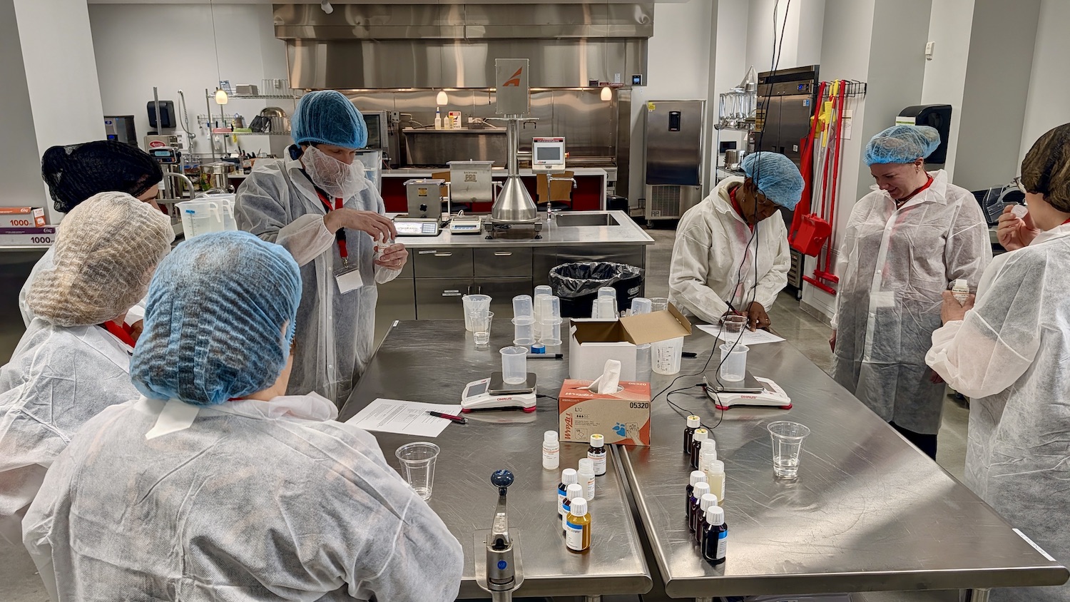 Seven people in a food science lab