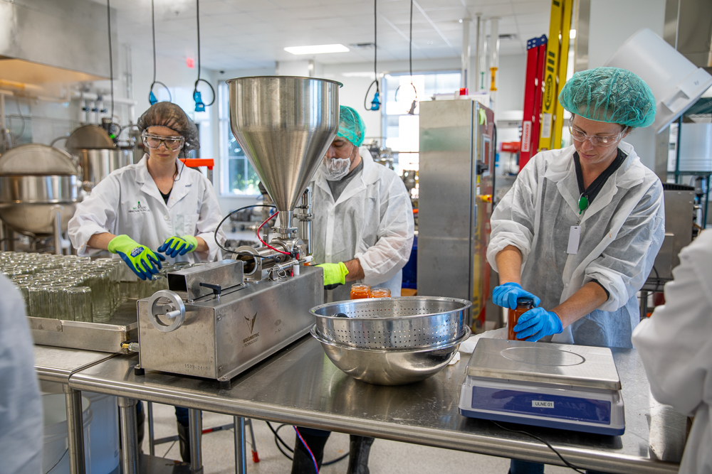 NCFIL team members work in the NCFIL facility jarring soup for mass distribution.