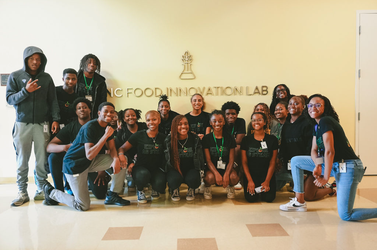 Sixteen high school students from the NCFIL summer camp pose together for a photo.